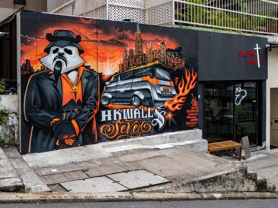 鸭巴甸街上SEVE创作的大型街头壁画，上面有一只身着西装的拟人化熊猫。 